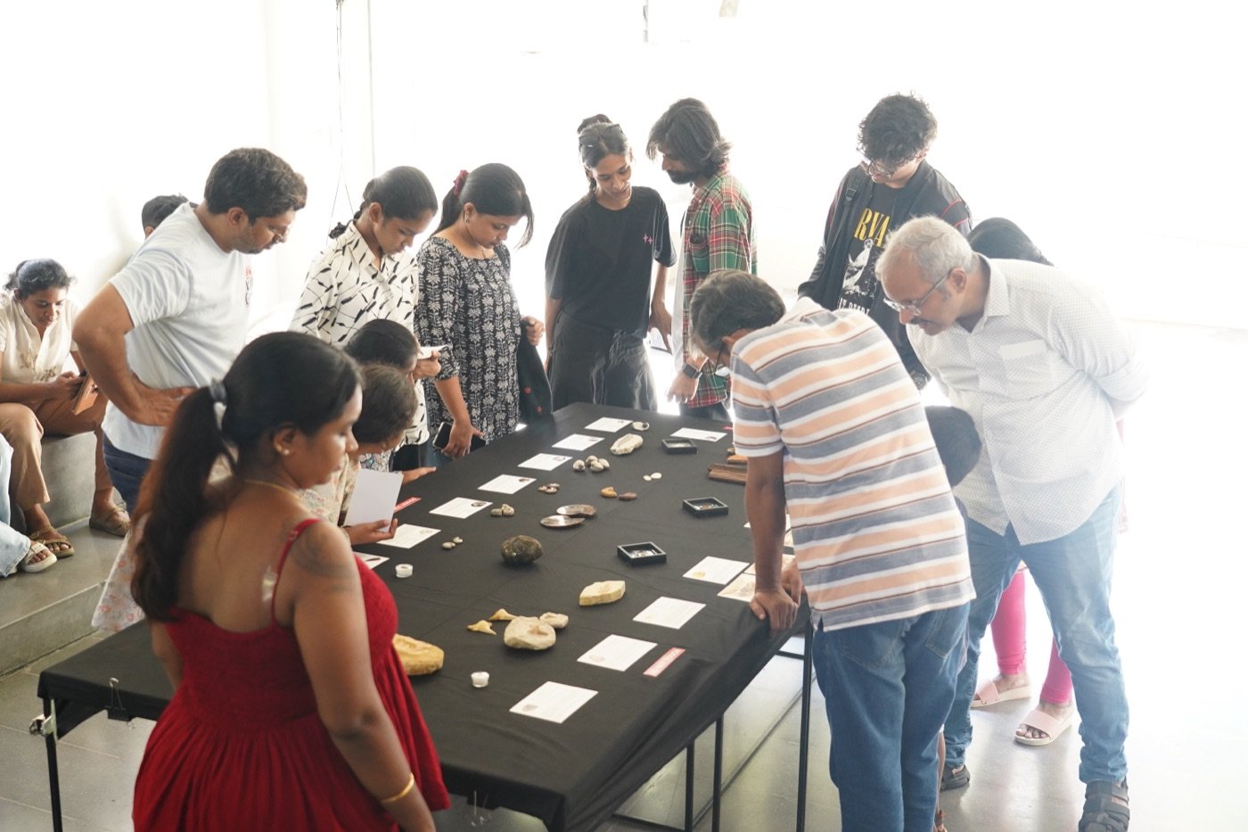 Visitors examining fossils and minerals on display in Chennai