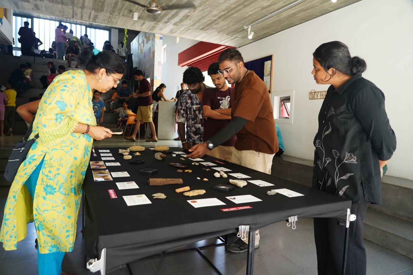 Visitors looking closely at the specimen table