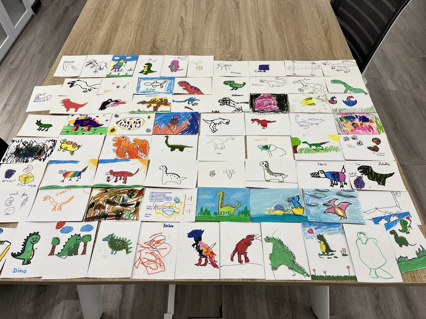 All the sketches by the kids who came to the show, laid out on a table
