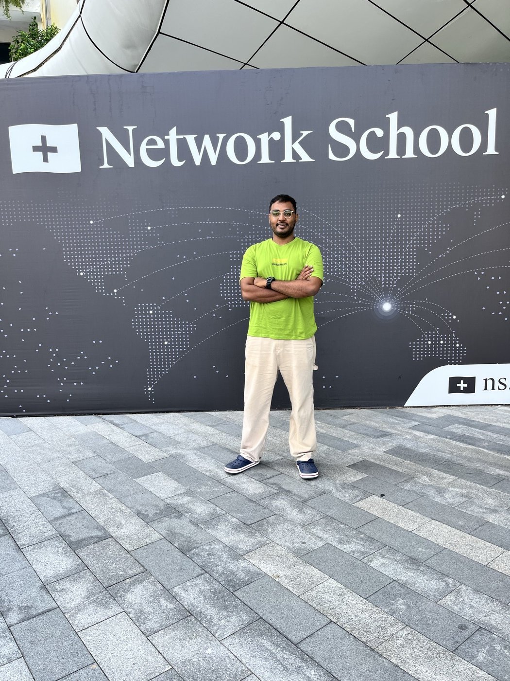SummerMaxi in front of the Network School sign